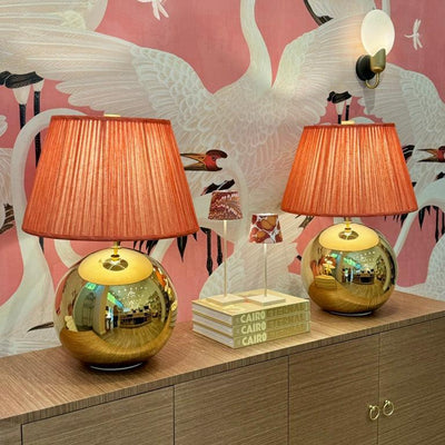 Large gold ball lamps and orange Fermoie lampshades