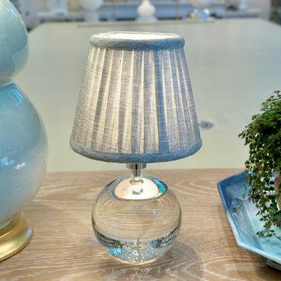 Luxury designer Fermoie Blue Moire gathered empire lampshade with pleated detailing displayed on a clear Tiny Terri Lamp