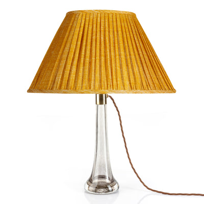 Front view of luxury designer Fermoie gathered empire oval lampshade in golden yellow fabric with pleated detailing