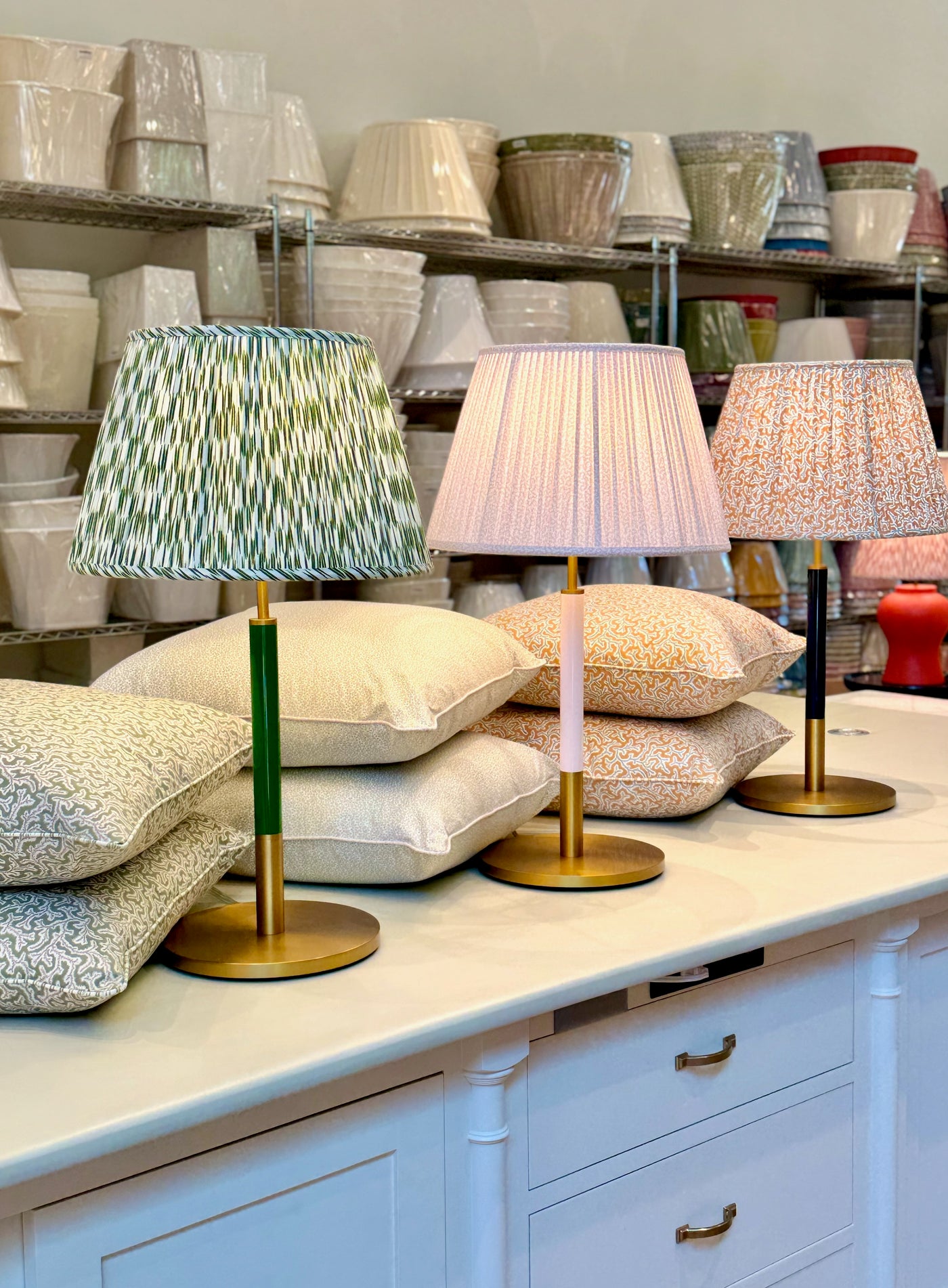 Group of Monroe Kate Spade lamp bases with Ian Sanderson lampshades and pillows.