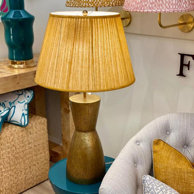 yellow fermoie lampshade on a brass lamp