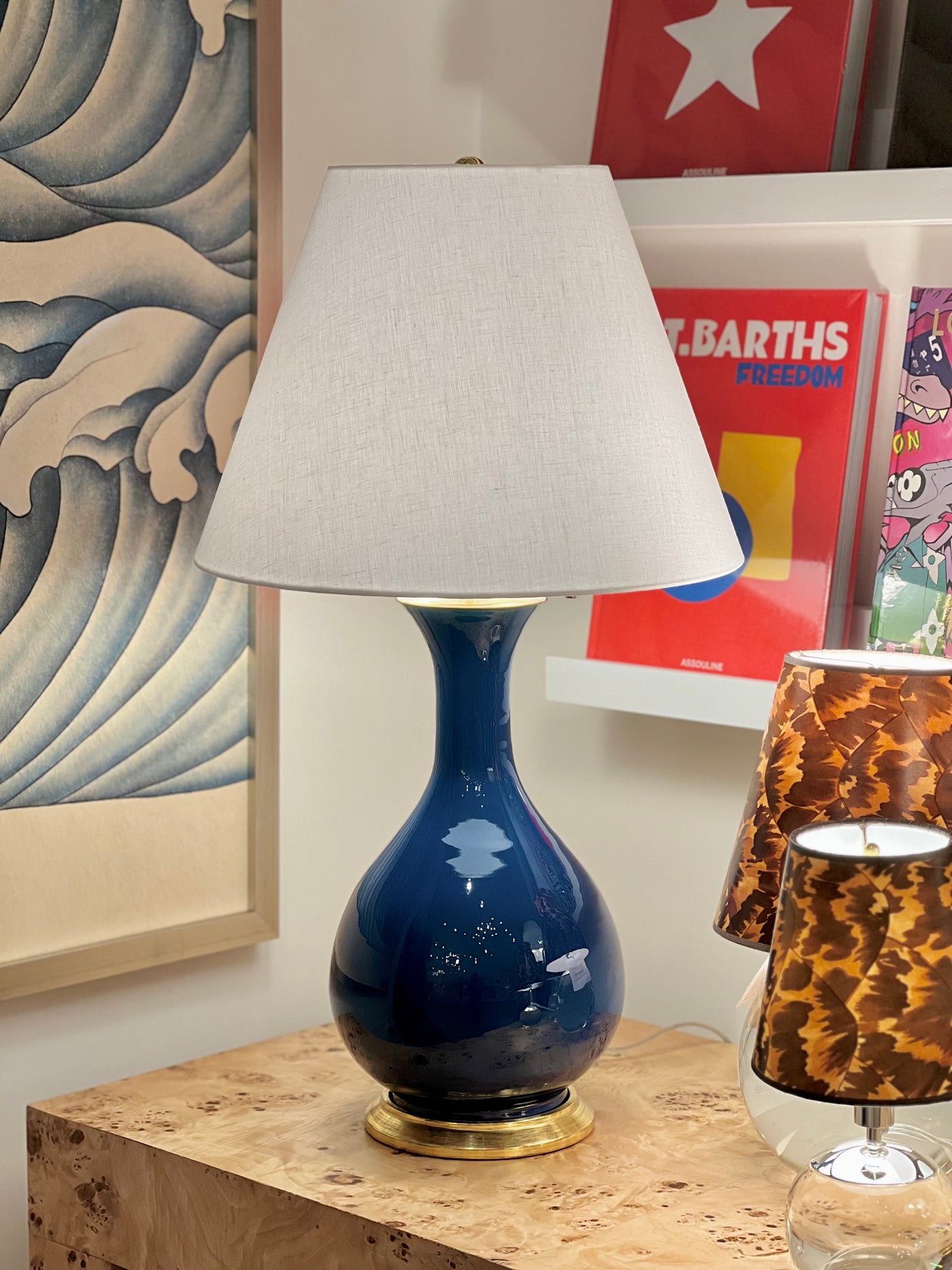 Hardback white linen lampshade on a blue lamp