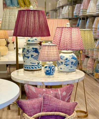 Pink fermoie lampshades on blue and white lamps