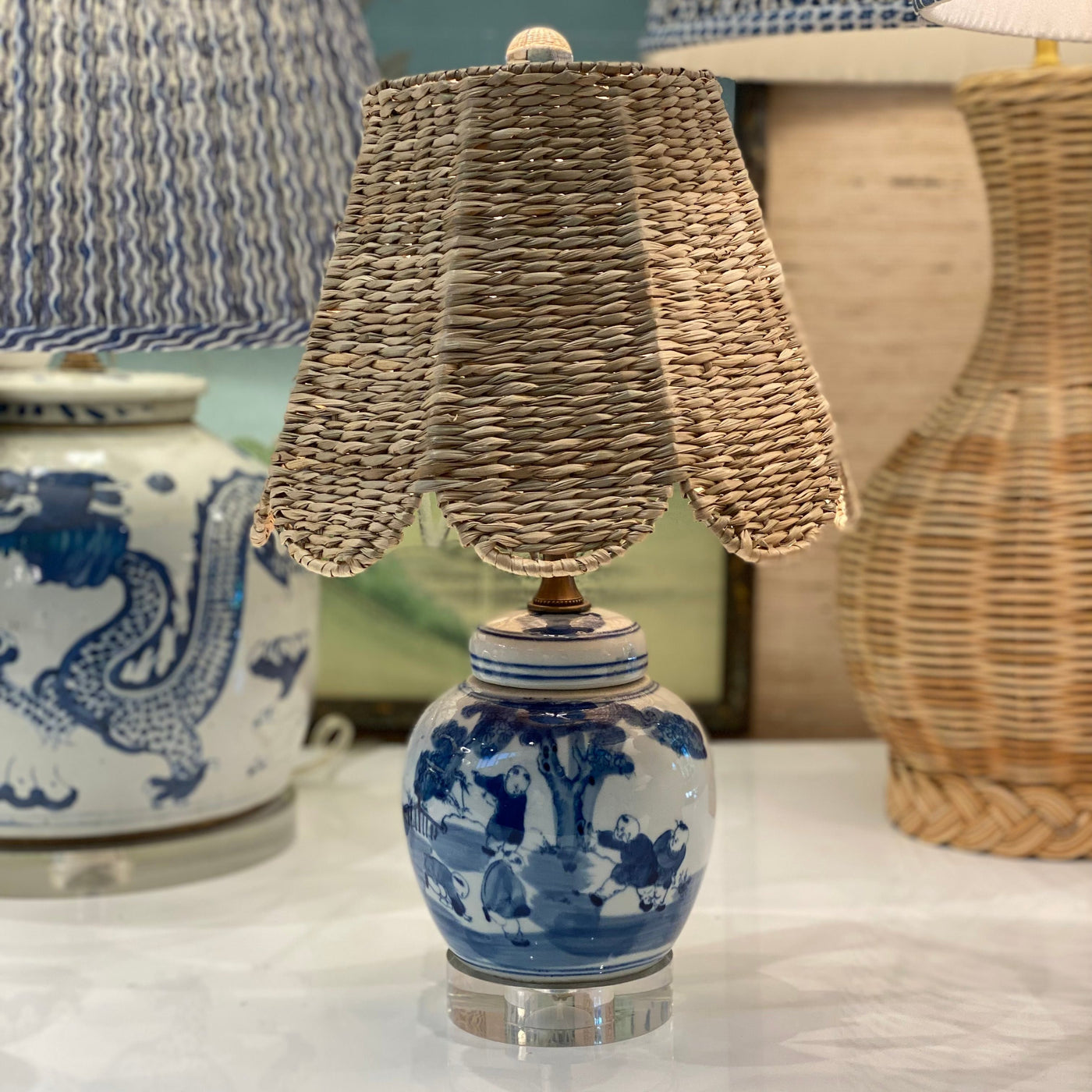 Scalloped seagrass lampshade on a mini blue and white lamp